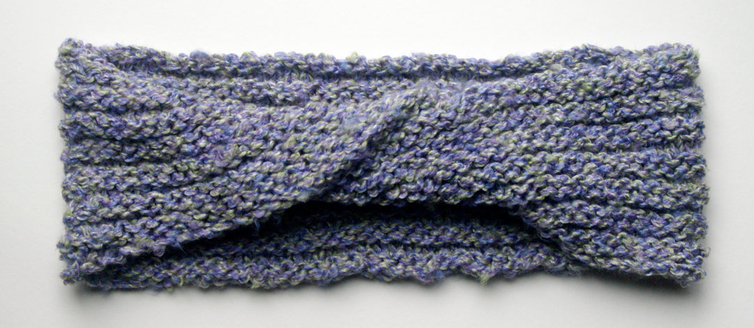 "Spring's Promise" Hand Knit Twisted Infinity Scarf was created with Loops & Threads Country Loom soft and cozy Super Bulky acrylic yarn in Lavender Blues colorway, flat.